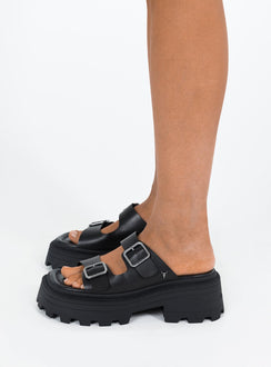 Black Sandals Faux leather material Platform base Square toe Double strap upper Silver toned buckles Padded footbed Treaded sole