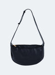 Black shoulder bag Faux leather material Adjustable shoulder strap Zip fastening  Gold toned hardware Flat base