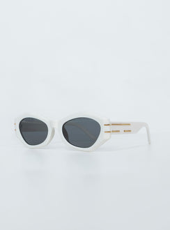 Sunglasses 95% plastic 5% metal UV 400 Hexagon frame  Moulded nose bridge  Black tinted lenses  Gold-toned hardware 