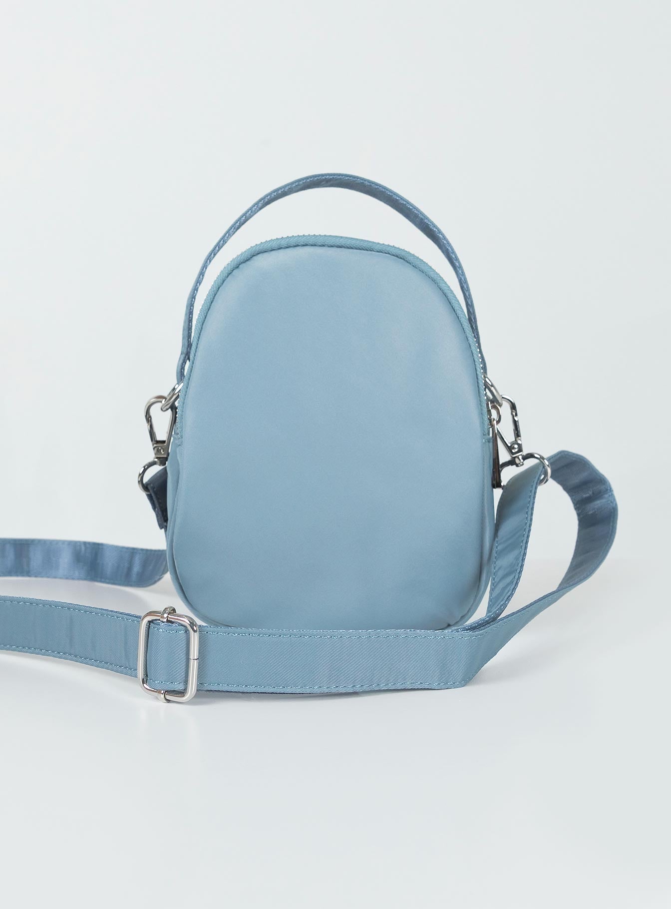 Crossbody bag Nylon material Fixed handle Adjustable & removable crossbody strap Three seperate compartments Zip fastenings Silver-toned hardware