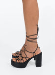 Black heels Faux leather material Strappy upper Shaved block heel Square toe Ankle wrap fastening