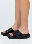 Black sandals Faux leather material Single wide upper Padded footbed Platform base