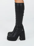 Knee high boots  Faux leather material  Platform base  Square toe  Block heel  Fitted leg 