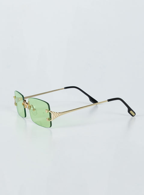 Sunglasses  50% PC 50% Metal UV 400 Frameless design  Gold-toned metal arms  Adjustable silicone nose pads  Green tinted lenses 