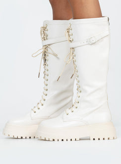 Boots Faux leather material  Zip fastening at back  Lace up front  Buckle strap at top  Platform base  Treaded sole 