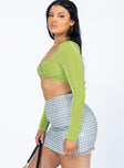   side view of model wearing Princess Polly Cove Mini Skirt Green 