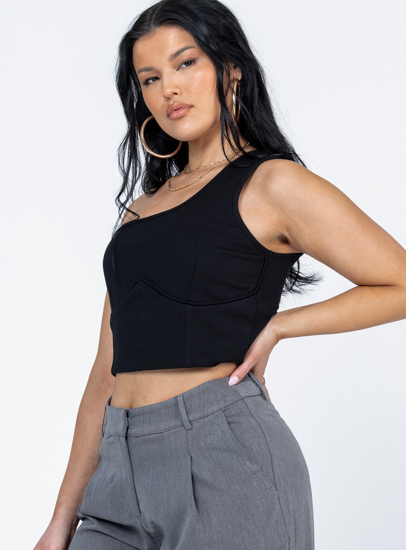 side view of model wearing Princess Polly Meranti Top Black Sleeveless Asymmetric Neckline 