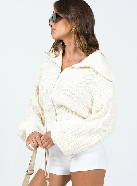Sweater 100% polyester  Knit material  Turtle neck  Zip front fastening  Drop shoulder  Cropped design 