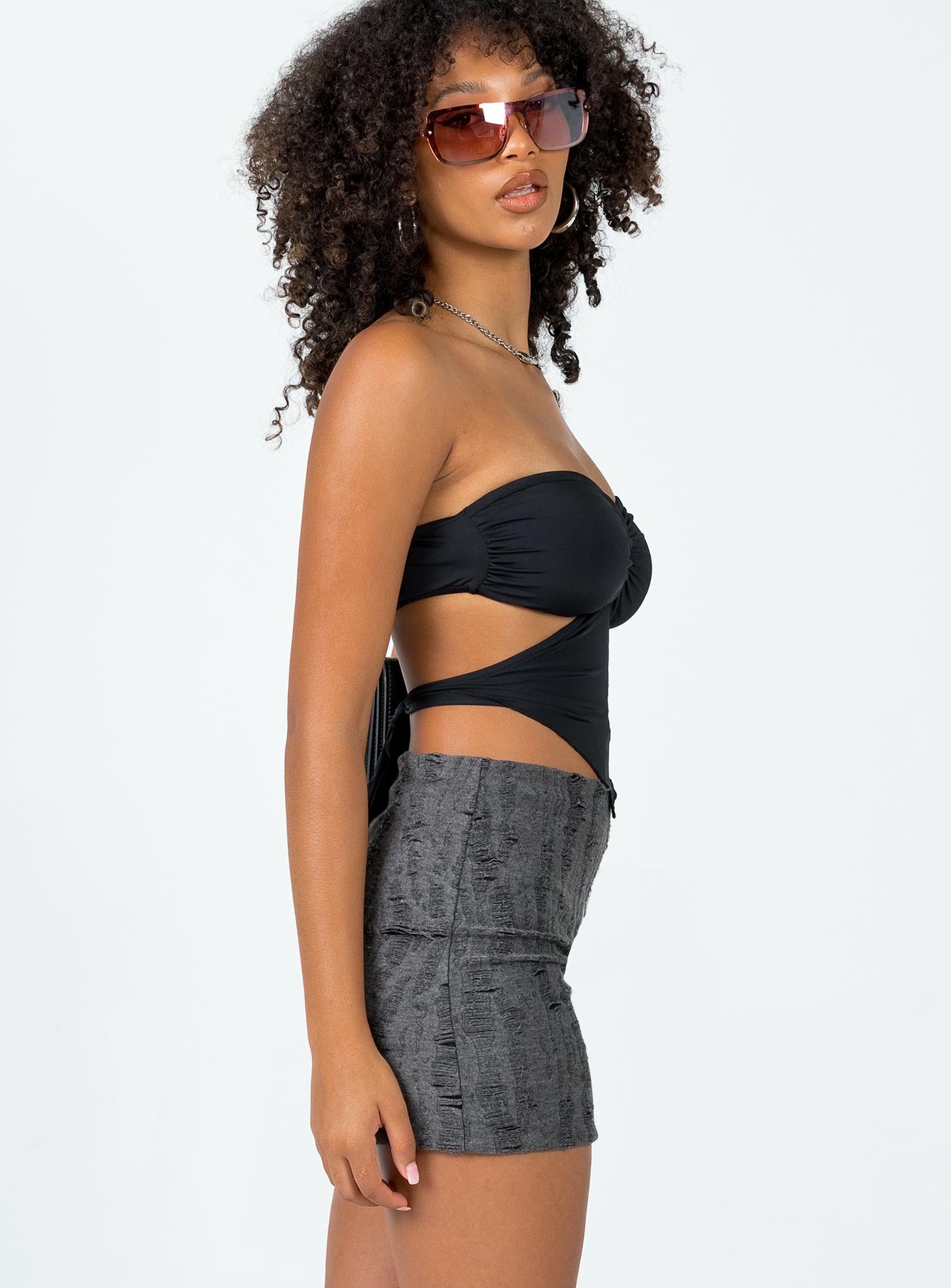   side view of model wearing Princess Polly Conan Mini Skirt Black Mini Skirts 