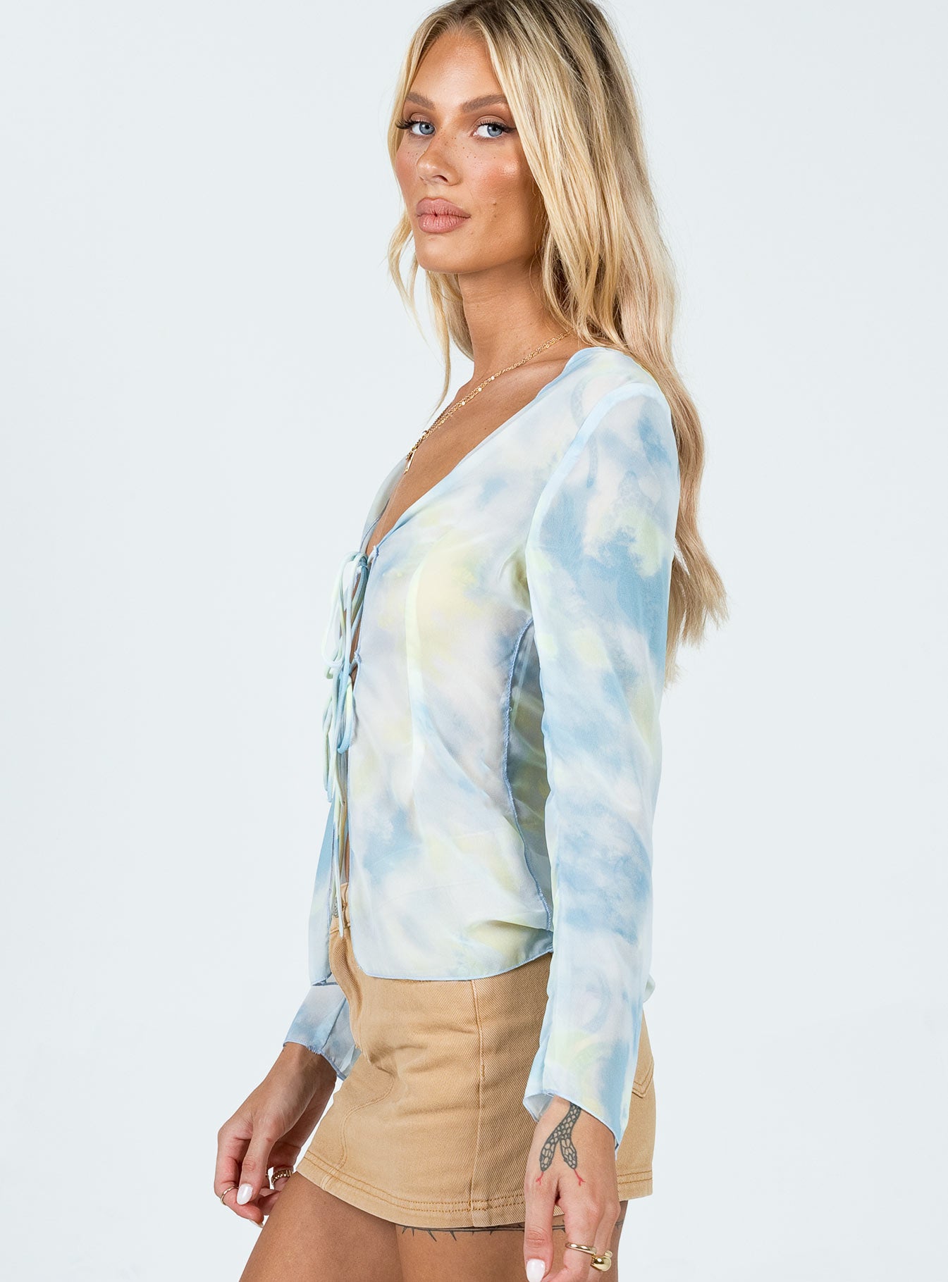 side view of model wearing Princess Polly Chosen Long Sleeve Top Blue 