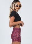   side view of model wearing Princess Polly Cairen Mini Skirt Red 