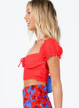 Red crop top Crinkle material  Elasticated shoulders  Tie fastening at bust  Fixed lace-up waist  Invisible zip fastening at side 