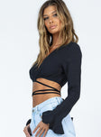 side view of model wearing Princess Polly Delano Long Sleeve Top Black Full Sleeves V-Neck 