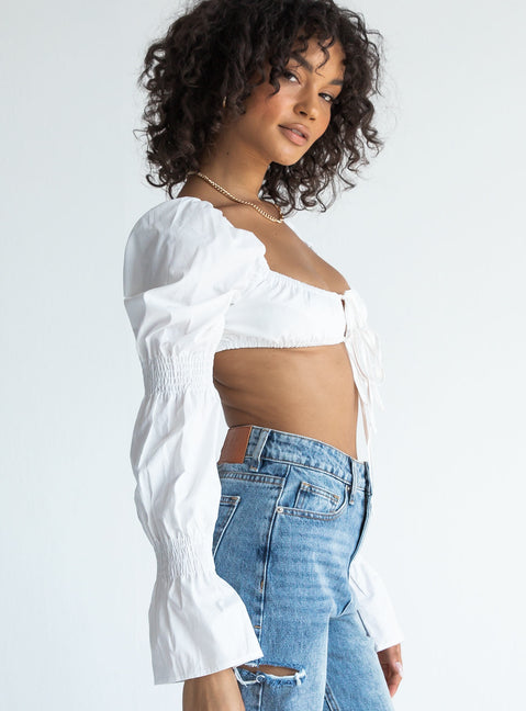 side view of model wearing Princess Polly Romina Long Sleeve Top White 