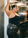 Front view of model wearing  front Princess Polly Sleeveless High Neck  Zora Satin Corset Top Black Curve