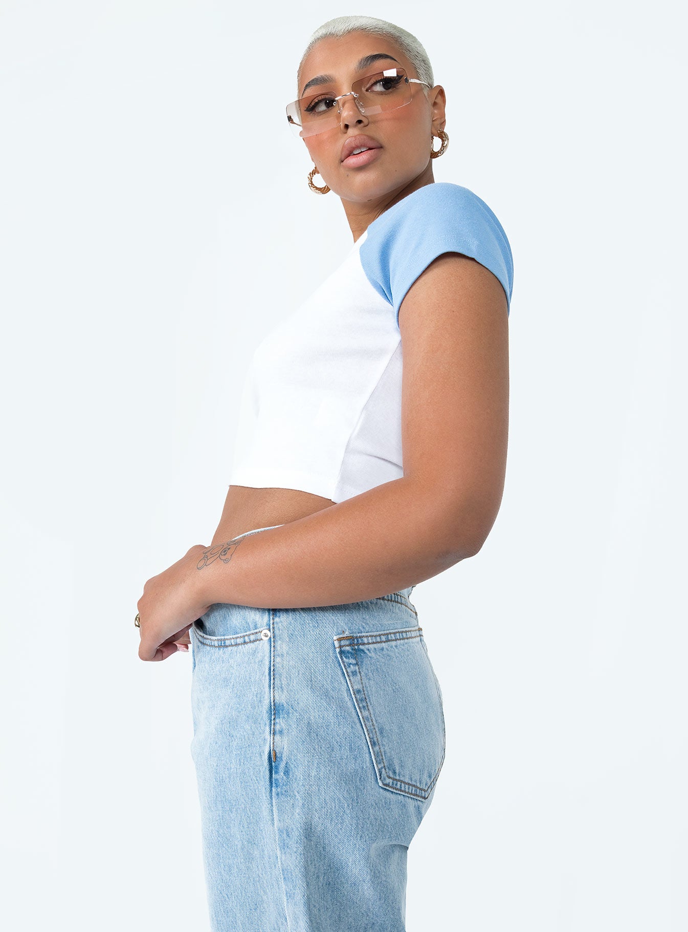 side view of model wearing Princess Polly Looney Tunes Two Flags Cropped Tee White / Blue Short Sleeves Crew Neck 