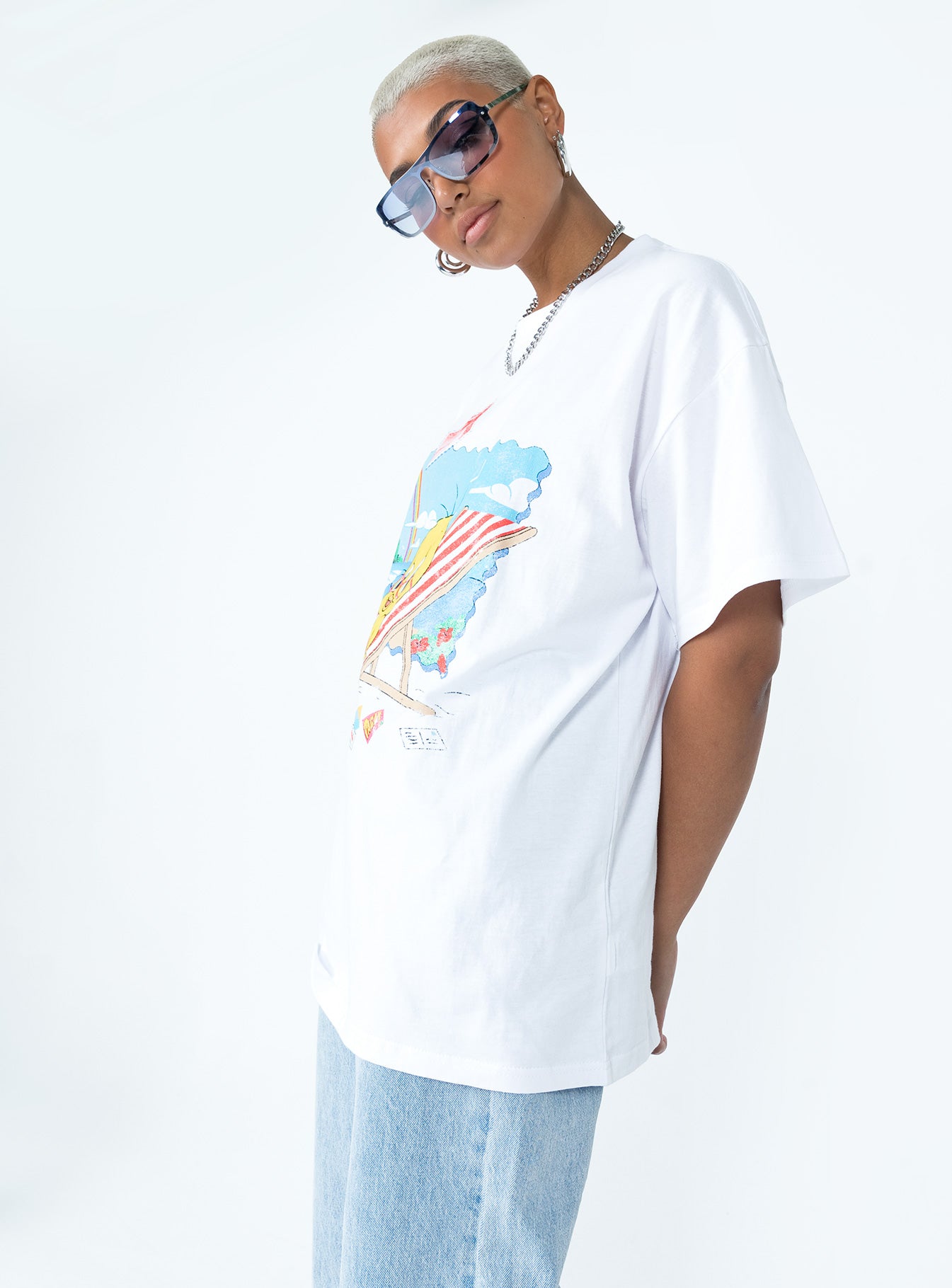 side view of model wearing Princess Polly Tweety Post Card Vacation Oversized Tee White Short Sleeve Crew Neck 