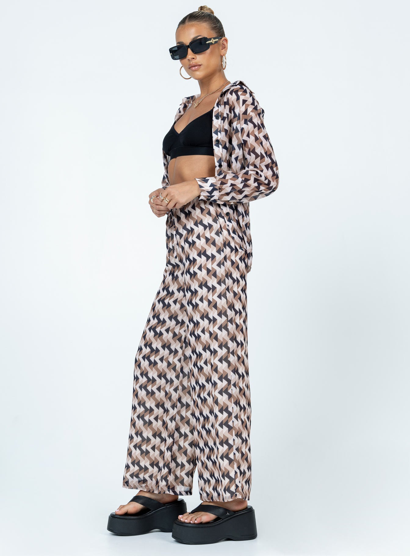 Matching set Sheer material  Geometric print  Button up shirt  High waisted pants  Elasticated drawstring waistband  Wide leg