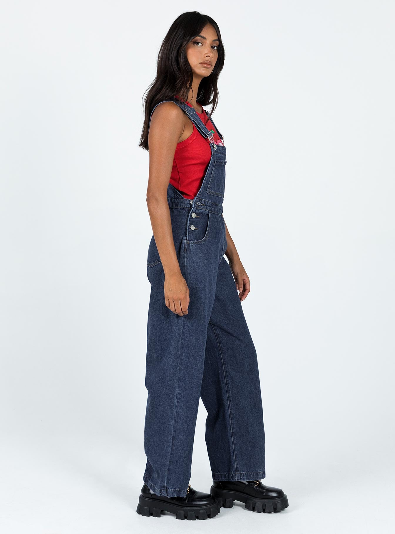 Overalls Cord material  Adjustable shoulder straps  Button fastening at hips  Chest pocket  Wide leg 