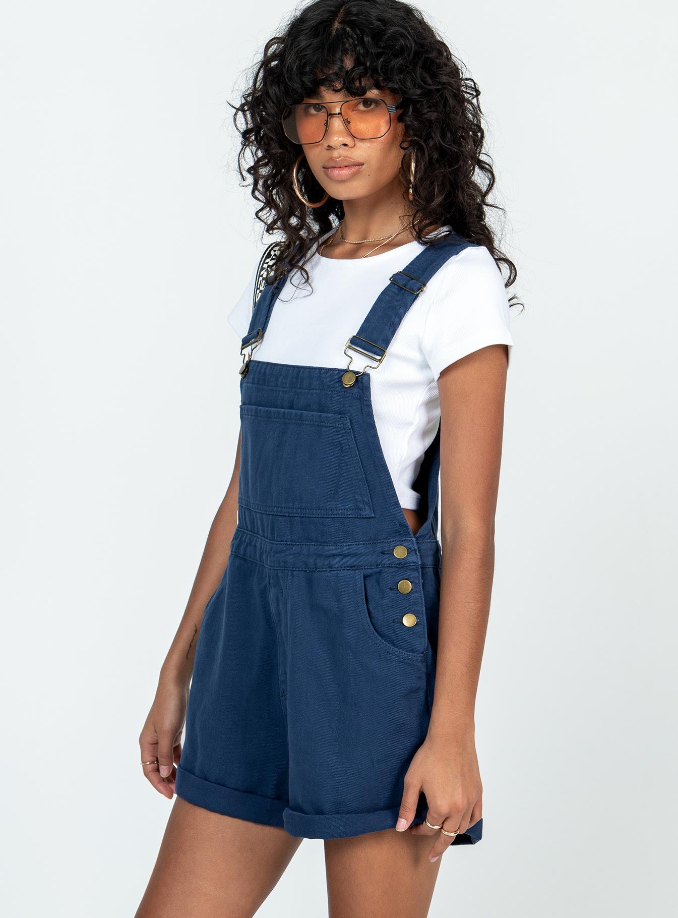 Overalls Denim material Adjustable buckle straps Button fastening at sides Large chest pocket Classic four pockets  Gold-toned hardware  Fixed rolled hem