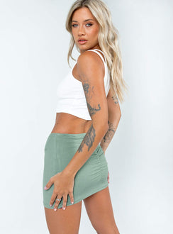   side view of model wearing Princess Polly Courtney Low Waist Mini Skirt Green Mini Skirts 