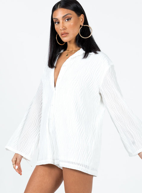 Long sleeve romper Textured material  Button front fastening  Wide sleeves 