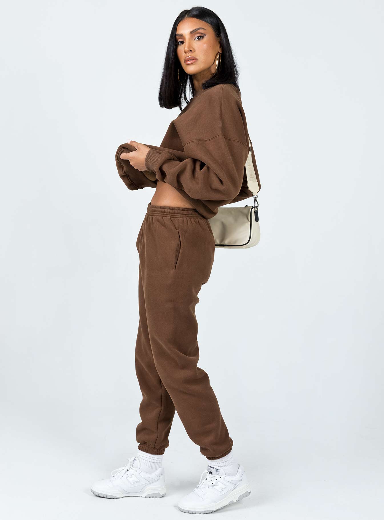 side view of model wearing Princess Polly Club Basic Trackpants Brown 