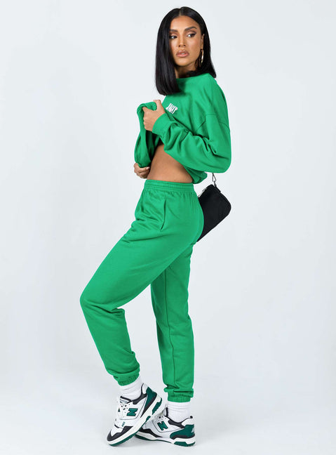 side view of model wearing Princess Polly Club Basic Trackpants Green 