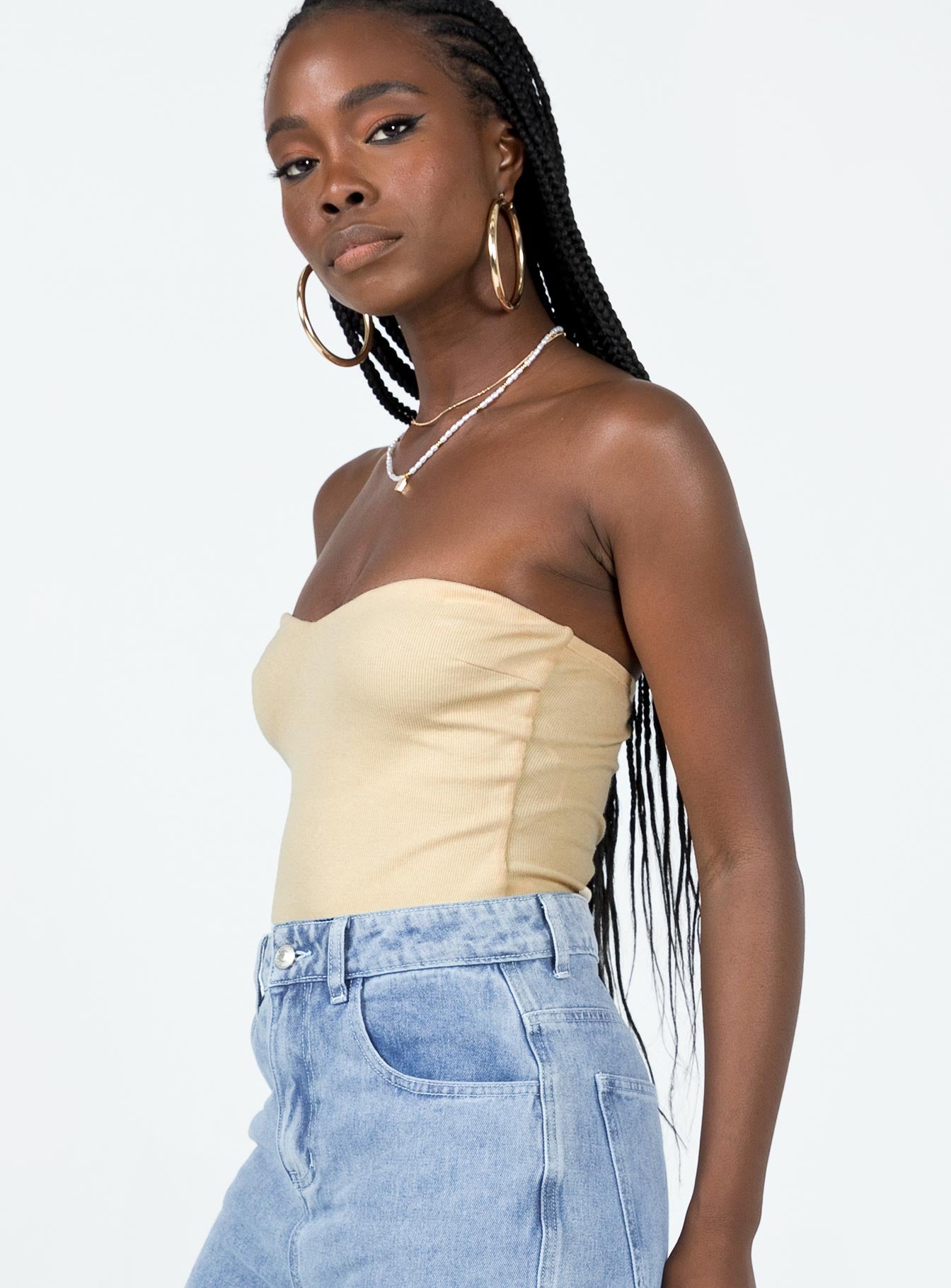 side view of model wearing Princess Polly Aston Strapless Bodysuit Cream Sleeveless Sweetheart 