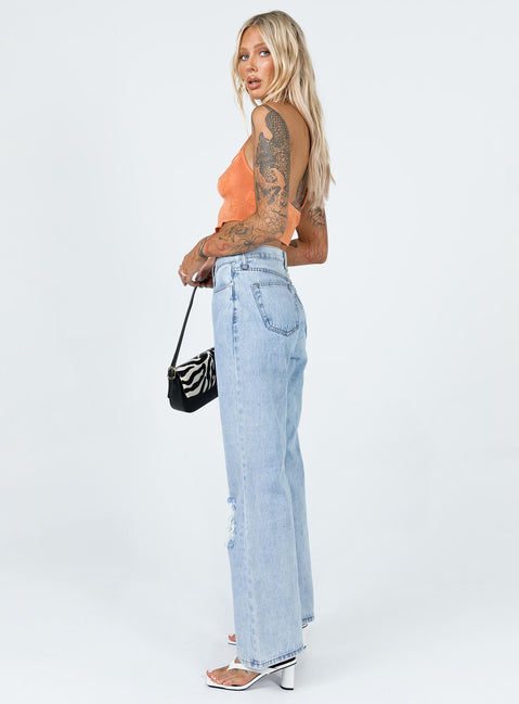 side view of model wearing Princess Polly Maple Flare Jeans Knee Rips Light Wash Denim Mid Rise 