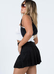   side view of model wearing Princess Polly Arlo Tennis Skirt Black 