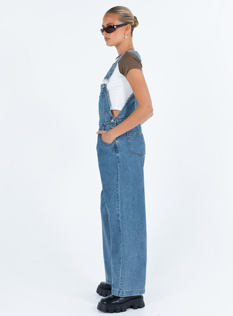 Overalls Mid wash denim Adjustable shoulder strap  Large chest pocket  Four classic pockets  Button fastening at hips  Wide leg