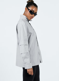 Jacket Windbreaker material High neck Zip front fastening Cargo style pocket on right sleeve Twin front pockets Press studs at cuff Drawstring hem