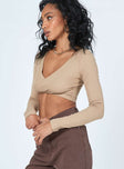 side view of model wearing Princess Polly Suri Long Sleeve Top Beige 