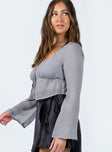 Long sleeve top Sheer material  Wide neckline  Hook fastening at bust  Adjustable tie fastening at waist  Flared sleeves 