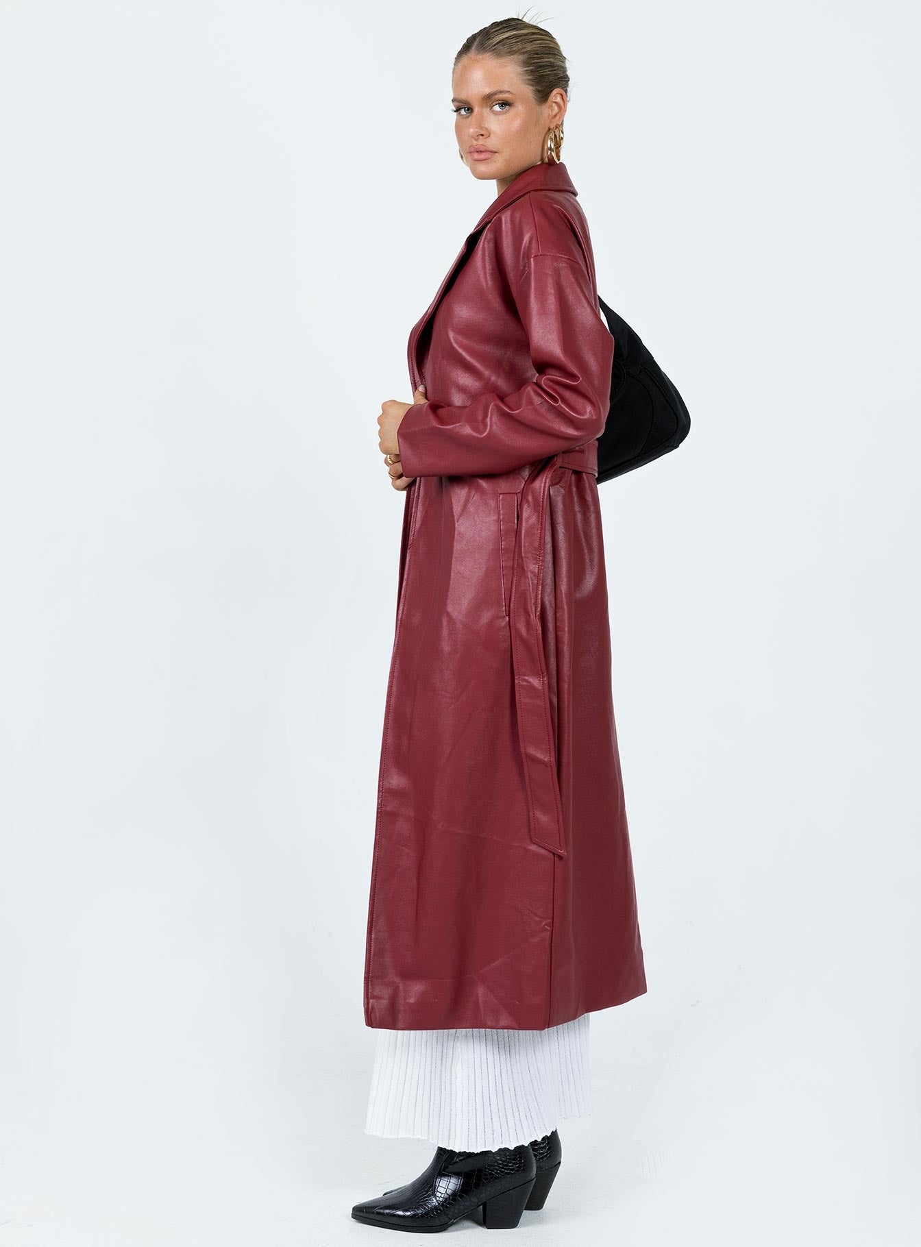 Long coat Faux leather material Lapel collar Removable waist tie Belt loops at waist Twin hip pockets Split hem at back