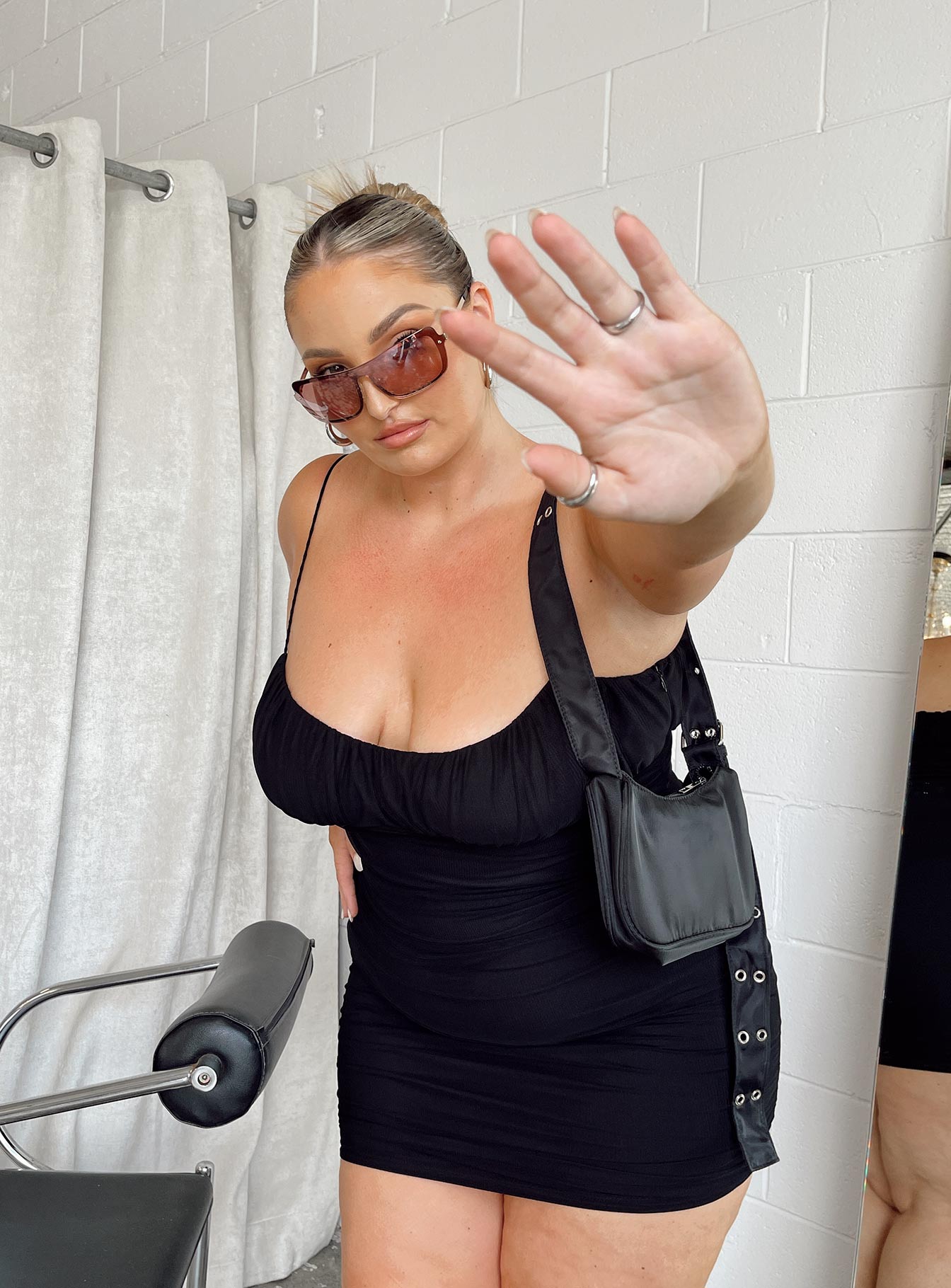 side view of model wearing Princess Polly Penney Mini Dress Black Curve 