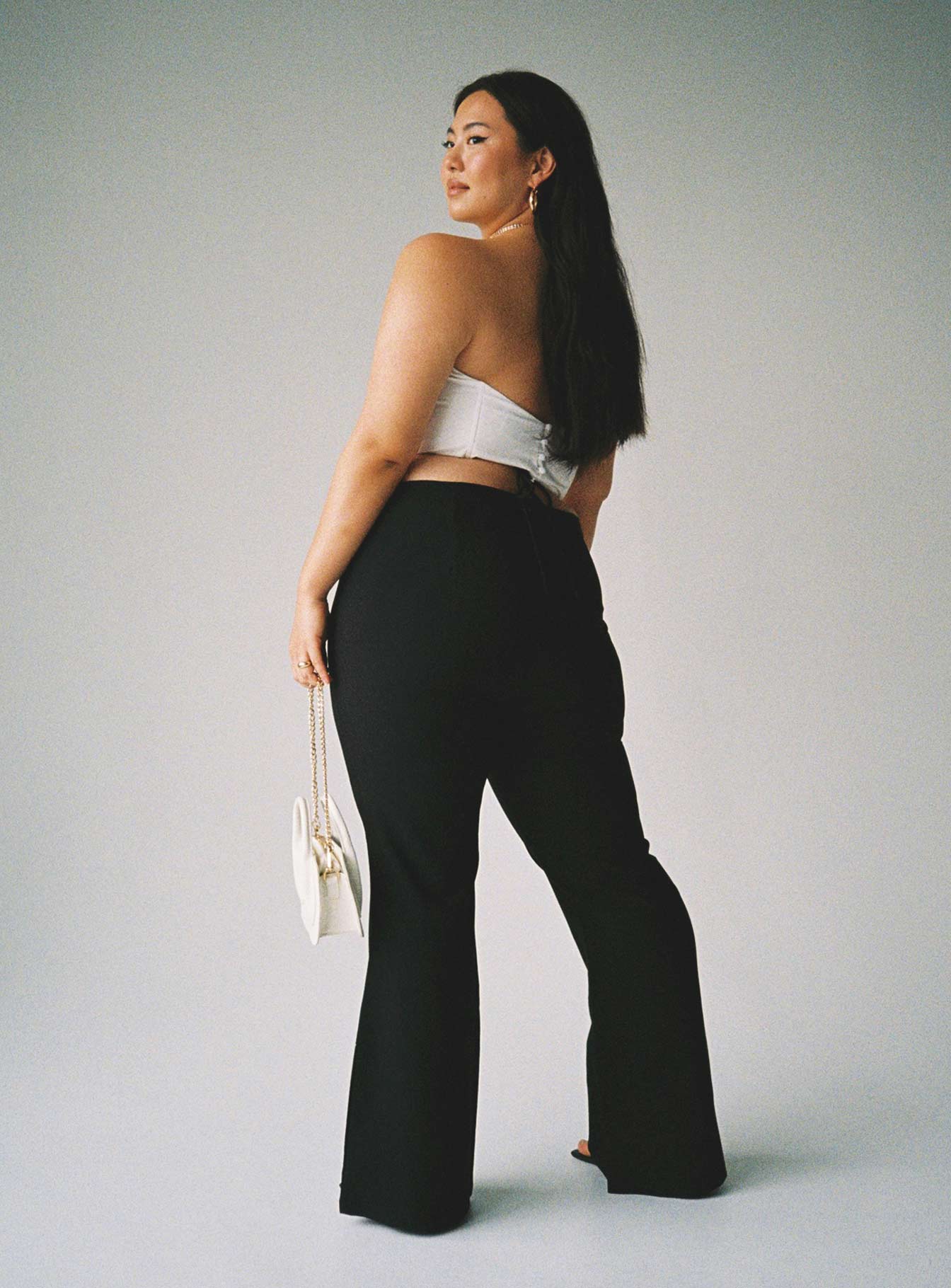 back view of model wearing Princess Polly Lovey Pants Black Curve 