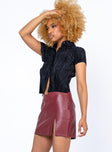   side view of model wearing Princess Polly Delancey Mini Skirt Burgundy 