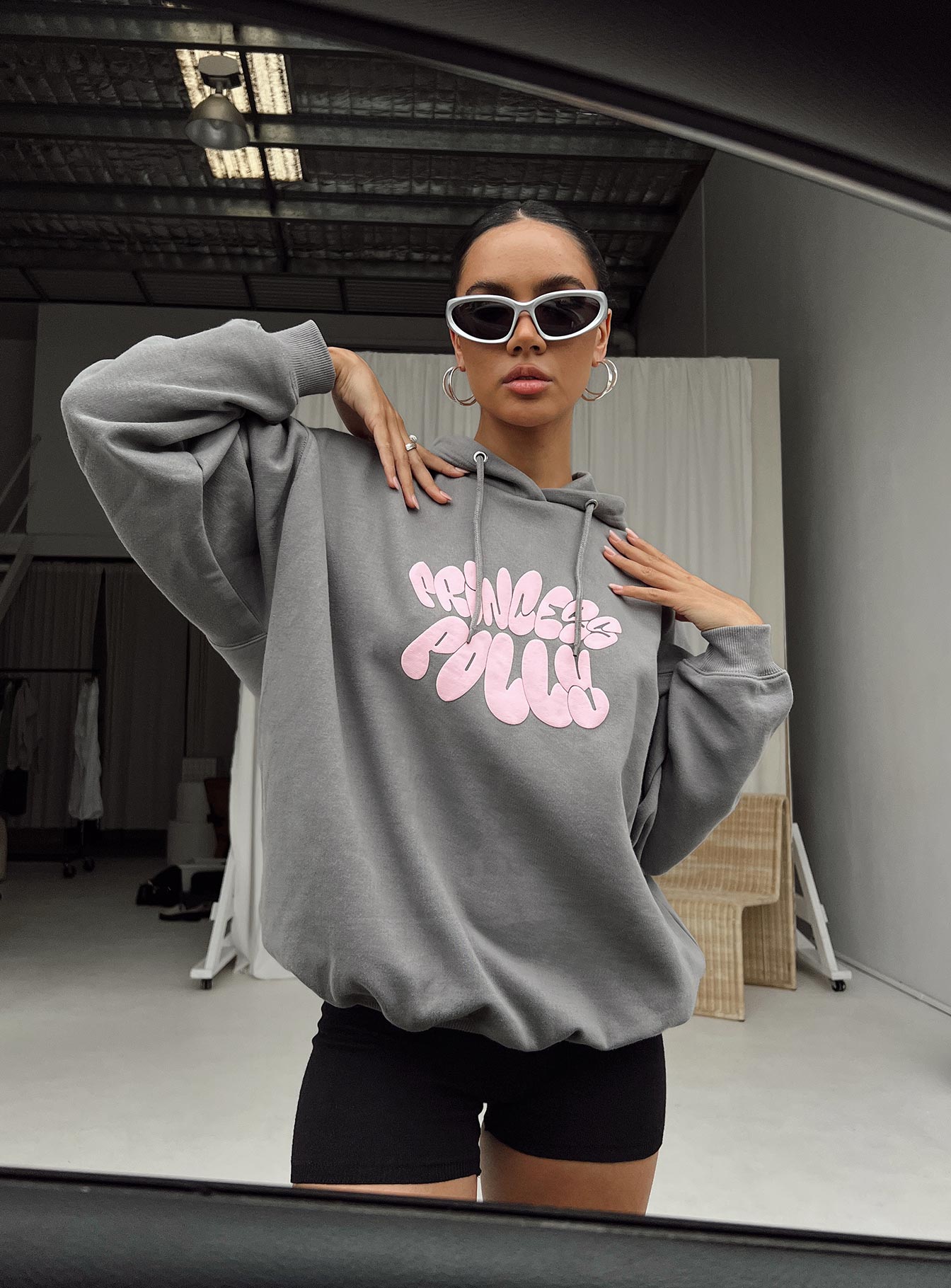 front view of model wearing Princess Polly Princess Polly Hooded Sweatshirt Bubble Text Charcoal / Light Pink Long 