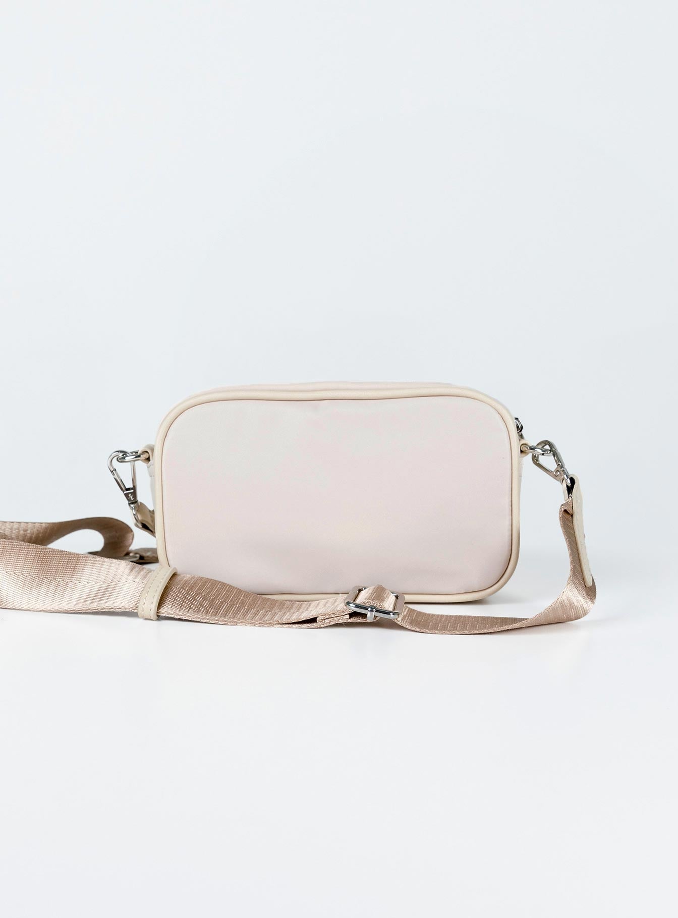Crossbody bag Nylon material  Silver-toned hardware  Three external pockets  Zip fastenings  Internal pockets  Removable & adjustable strap  Flat base