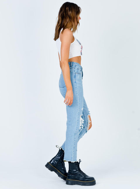 side view of model wearing Princess Polly Erissa Knee Rip Jeans Light Wash Denim Mid Rise 