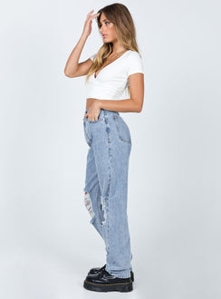 Front view of model wearing  front Princess Polly Mid Rise  Holly Asymmetric Ripped Leg Jeans Light Wash Denim