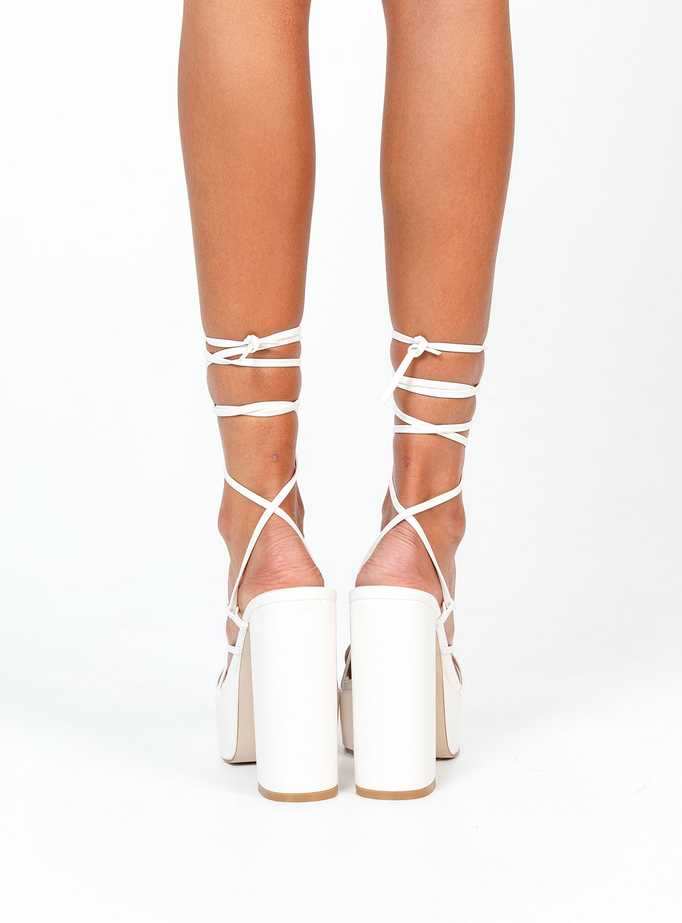 White heels Faux leather material  Strappy upper  Ankle tie fastening  Platform base  Block heel  Square toe 