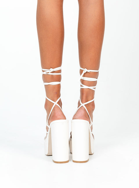 White heels Faux leather material  Strappy upper  Ankle tie fastening  Platform base  Block heel  Square toe 