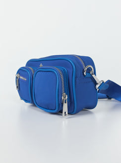 Crossbody bag Nylon material  Silver-toned hardware  Three external pockets  Zip fastenings  Internal pockets  Removable & adjustable strap 