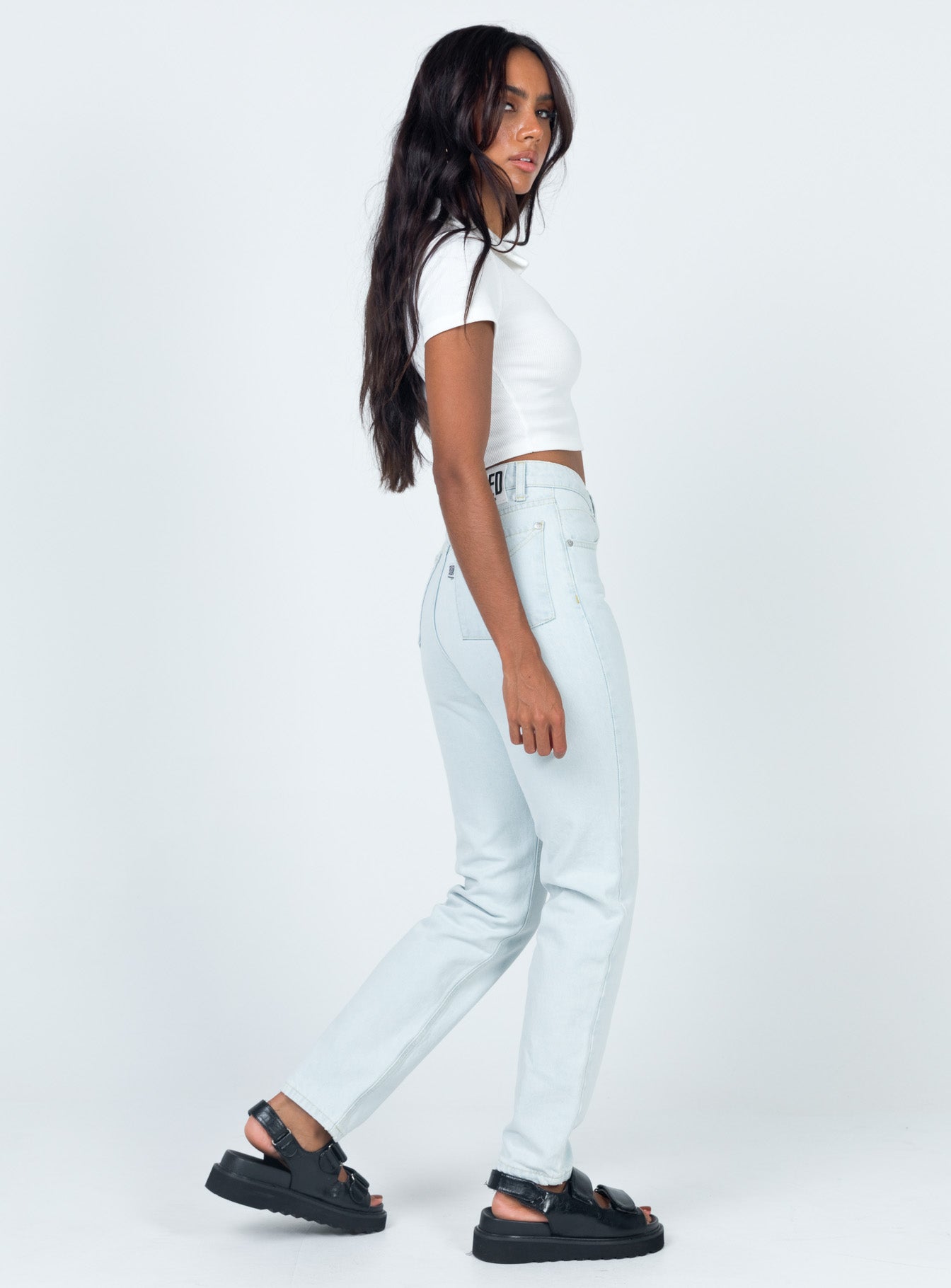 side view of model wearing Princess Polly Ragged Priest Cougar Jeans Stonewash Denim Mid Rise 