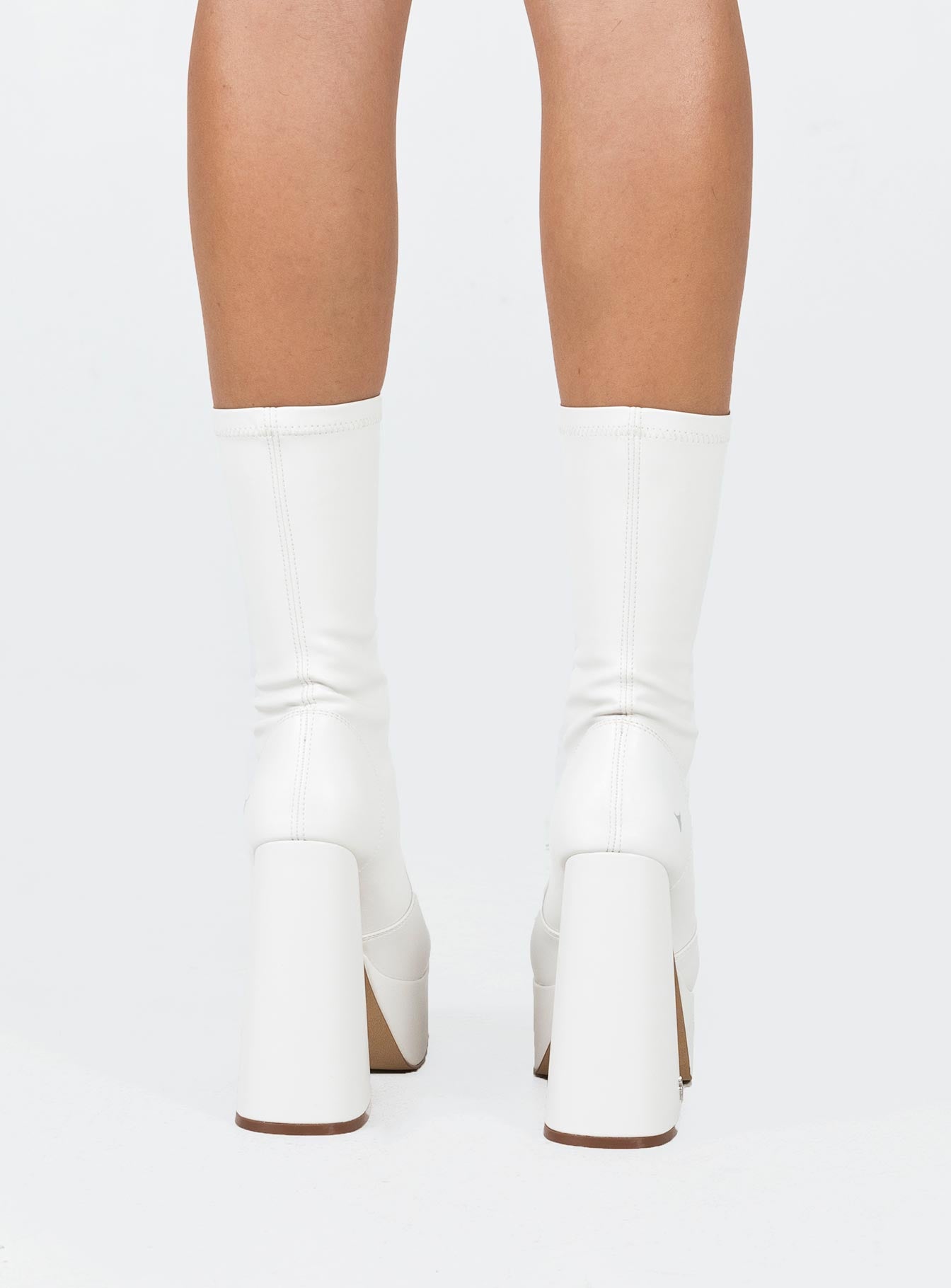 Boots  Faux leather material  Fitted at leg  Block heel  Platform base  Square toe  Slight stretch 