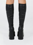 Knee high boots  Faux leather material  Platform base  Square toe  Block heel  Fitted leg 