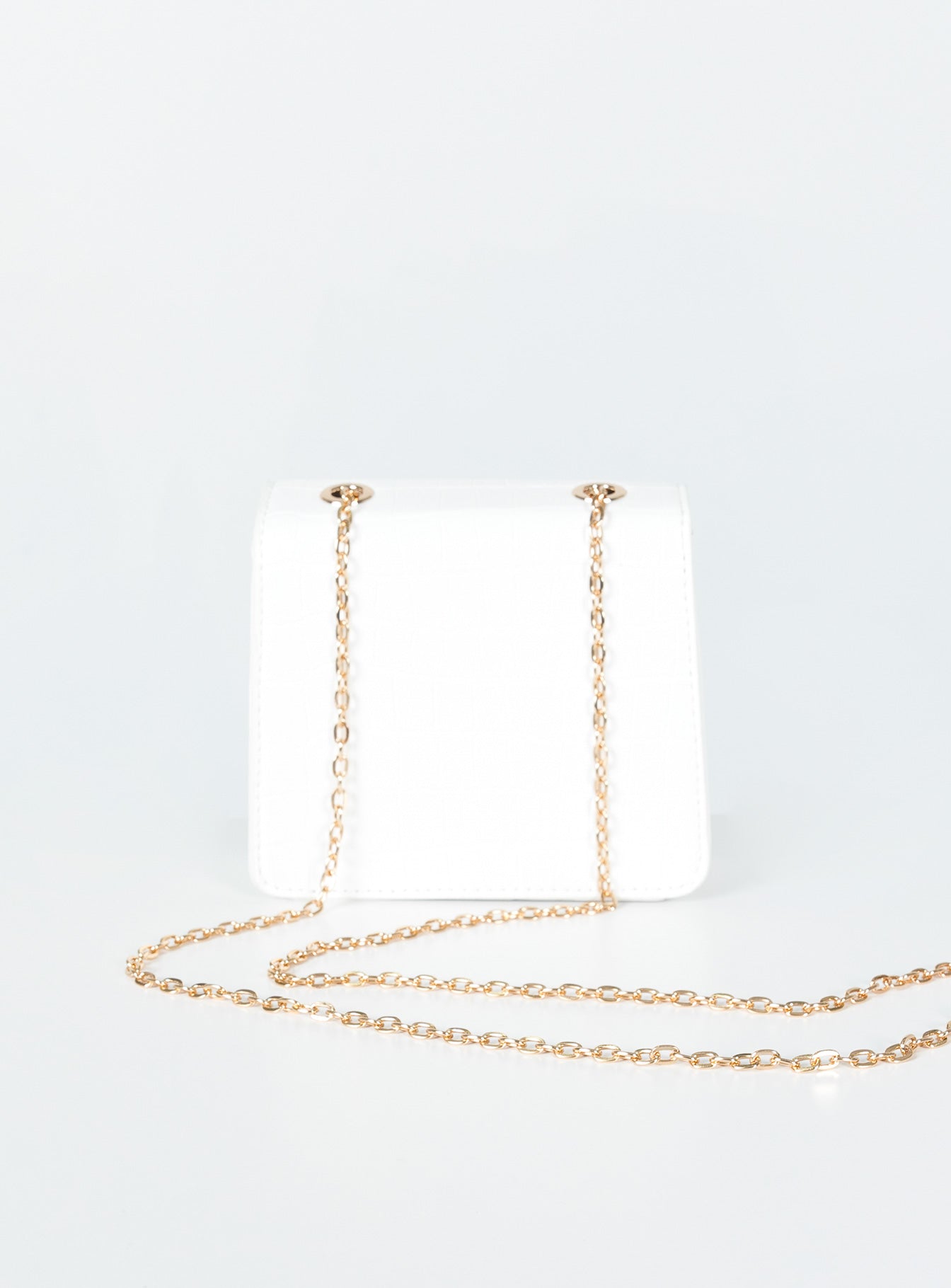 Crossbody bag  Princess Polly Exclusive 100% PU  Faux leather material  Croc print Gold-toned chain strap  Magnetic button fastening  Flat base